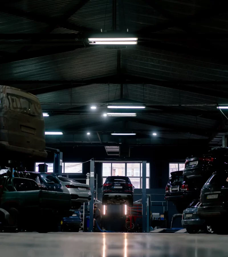 A night light at a warehouse full cars being stored